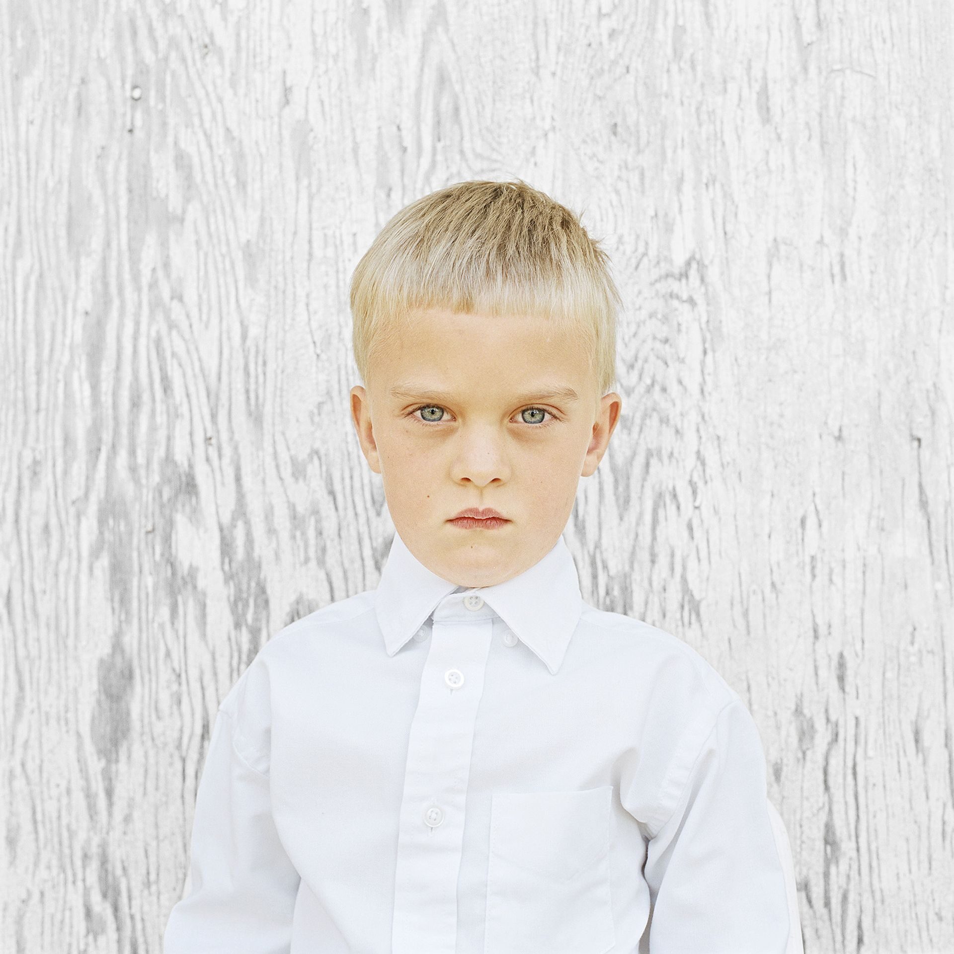 Portrait of a young blond boy with blue eyes