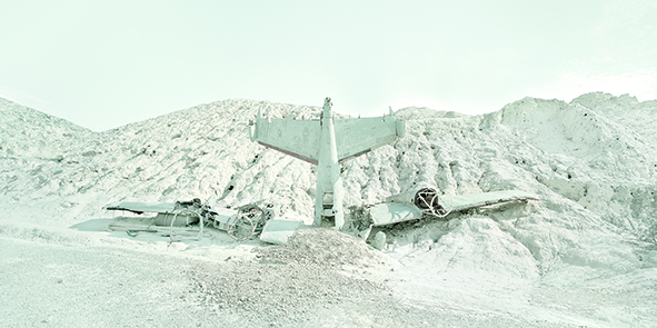 Plane crashed on the ground, nose forward, in the desert of Nevada.